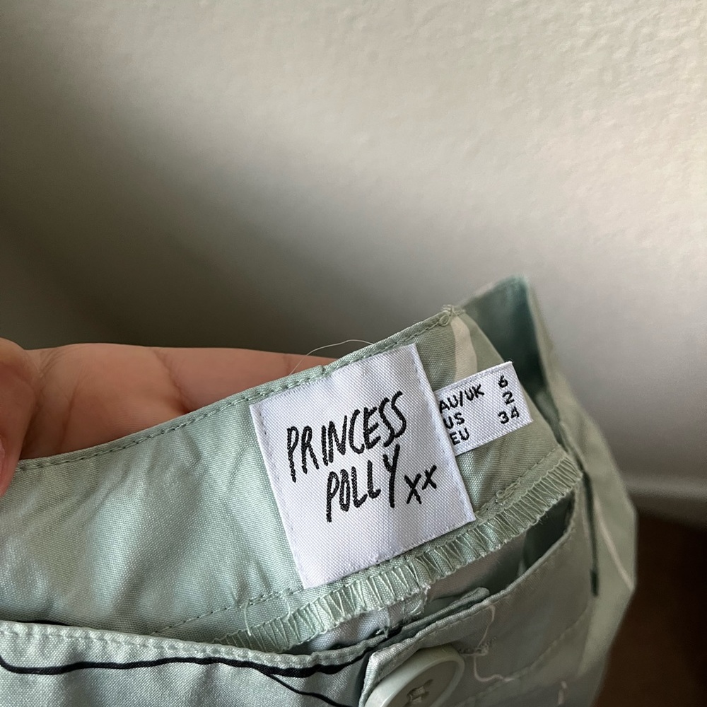 Princess Polly pants with white and black facial prints